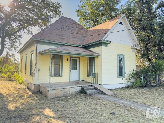 901 S Walnut St, Brady, TX 76825 - view of front of home with covered porch, a shingled roof, and a gate