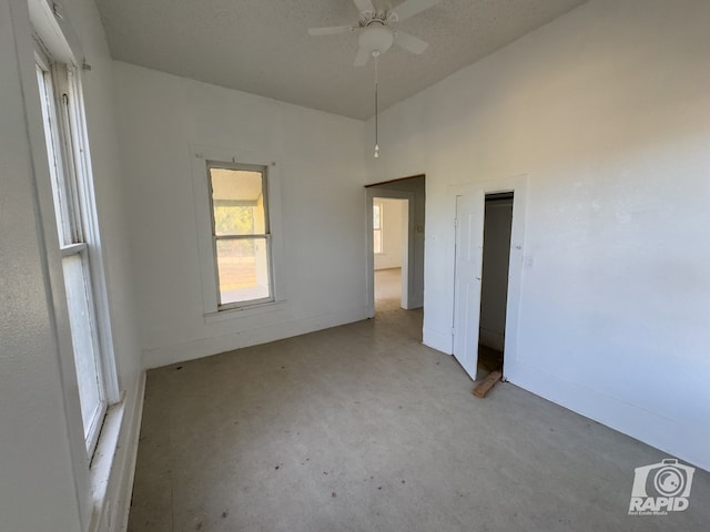 901 S Walnut St, Brady, TX 76825 - unfurnished bedroom featuring baseboards and high vaulted ceiling