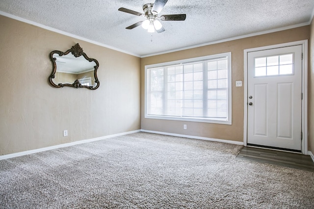 1619 Spaulding St, San Angelo, TX 76905 - foyer featuring carpet floors, a textured ceiling, a ceiling fan, crown molding, and a textured wall