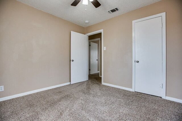 1619 Spaulding St, San Angelo, TX 76905 - unfurnished bedroom featuring carpet floors, a textured ceiling, and a ceiling fan