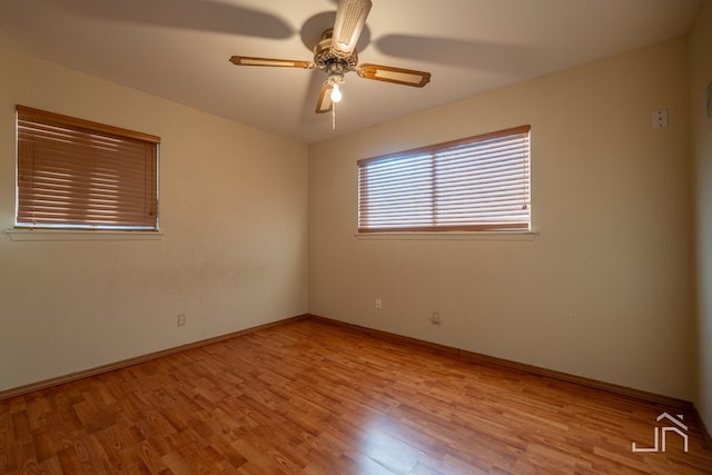 spare room featuring light hardwood / wood-style flooring and ceiling fan