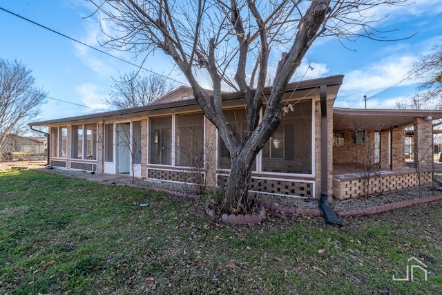 view of front of property featuring a sunroom and a front yard