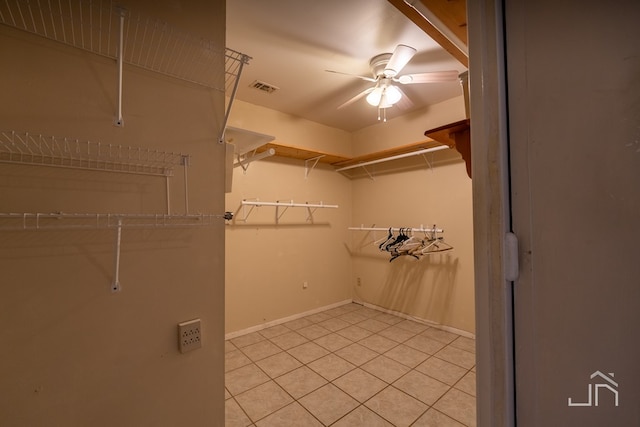 spacious closet featuring light tile patterned floors and ceiling fan