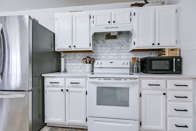 kitchen with black microwave, light countertops, freestanding refrigerator, under cabinet range hood, and electric range