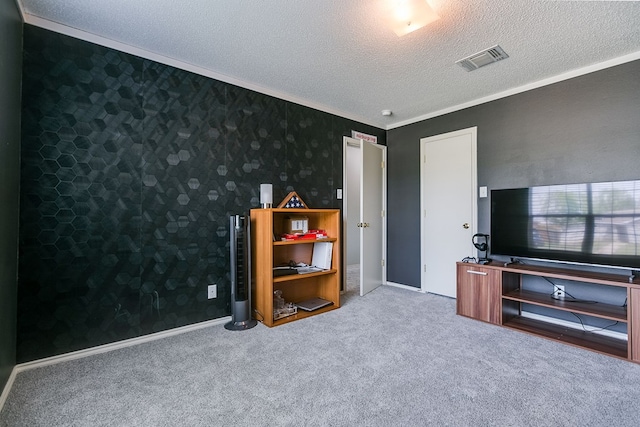 interior space featuring baseboards, visible vents, ornamental molding, and a textured ceiling