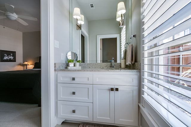 ensuite bathroom with visible vents, vanity, ensuite bath, and a ceiling fan