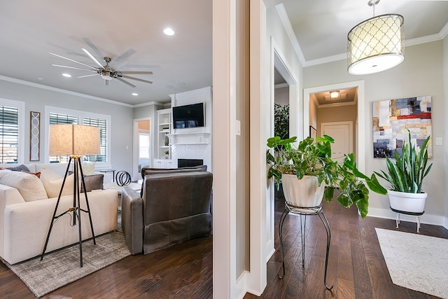 living room featuring ceiling fan, recessed lighting, dark wood finished floors, and crown molding