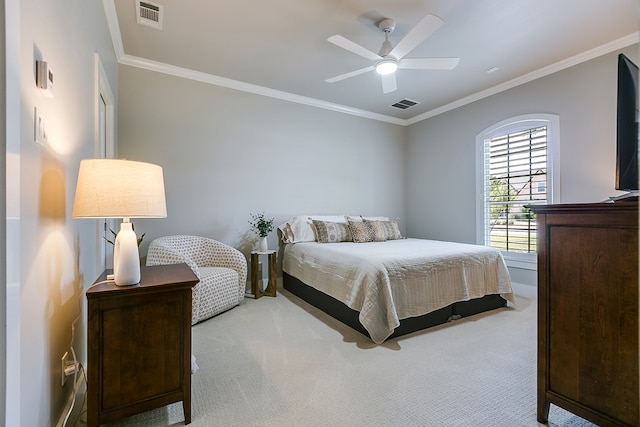 carpeted bedroom featuring visible vents, a ceiling fan, and crown molding