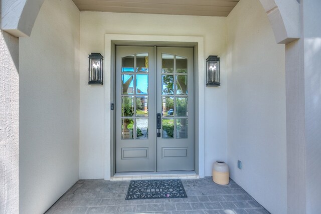 doorway to property with french doors and stucco siding