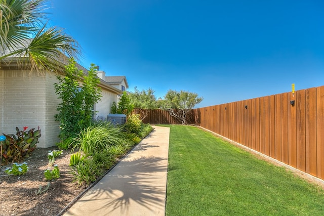 view of yard featuring central air condition unit and a fenced backyard