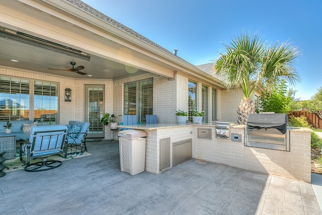 view of patio / terrace with ceiling fan, area for grilling, fence, and a grill