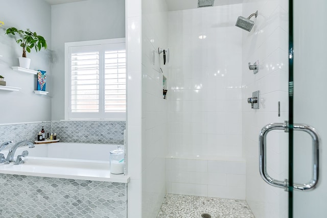 full bath featuring a garden tub and a stall shower