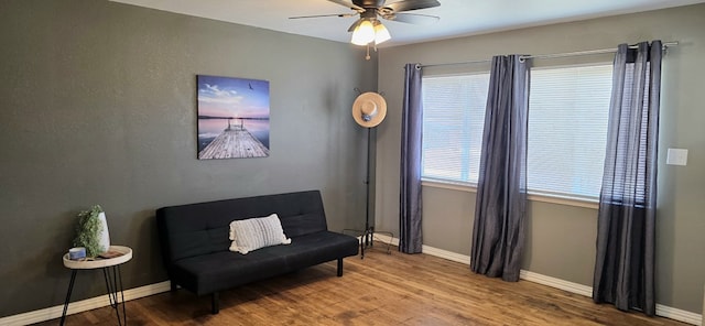 living area featuring ceiling fan, wood finished floors, and baseboards