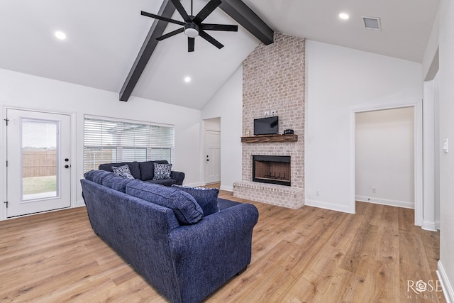 living room with beam ceiling, high vaulted ceiling, ceiling fan, a fireplace, and light hardwood / wood-style floors