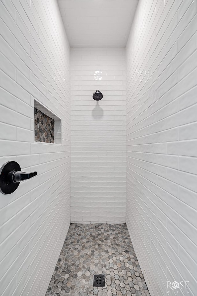 bathroom with a tile shower