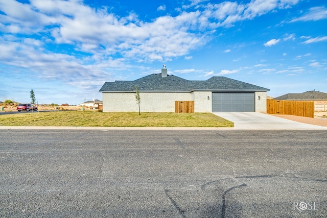 ranch-style home with a garage and a front yard