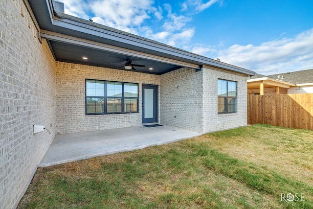 exterior space with a yard, ceiling fan, and a patio area