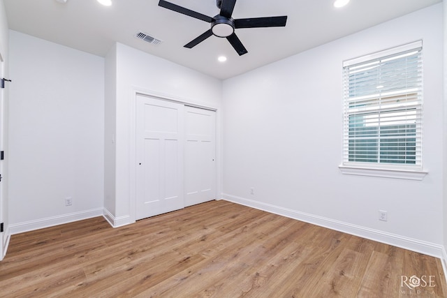 unfurnished bedroom with a closet, ceiling fan, and light wood-type flooring