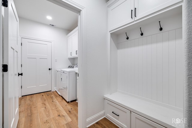 mudroom featuring light hardwood / wood-style flooring and washer and dryer