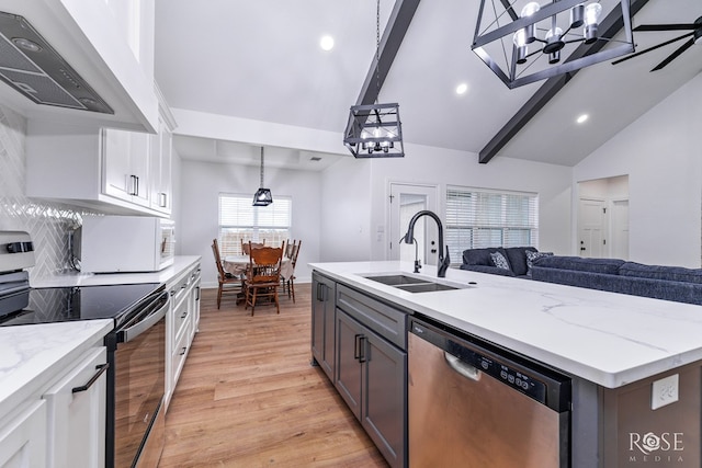 kitchen featuring premium range hood, sink, white cabinets, light hardwood / wood-style floors, and stainless steel appliances