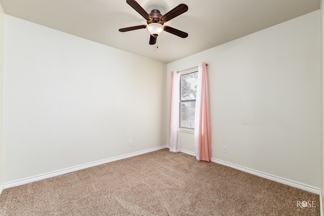 empty room with carpet, baseboards, and ceiling fan