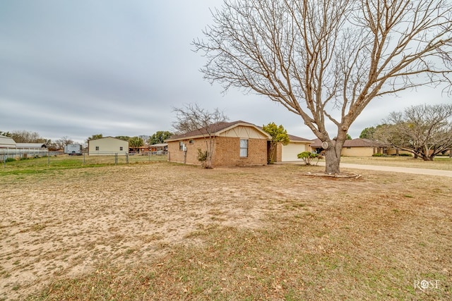 exterior space featuring a garage, driveway, and fence