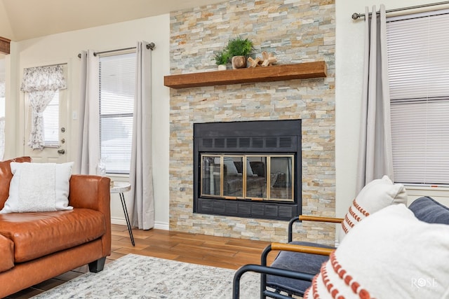 interior space featuring light wood-style floors and a stone fireplace