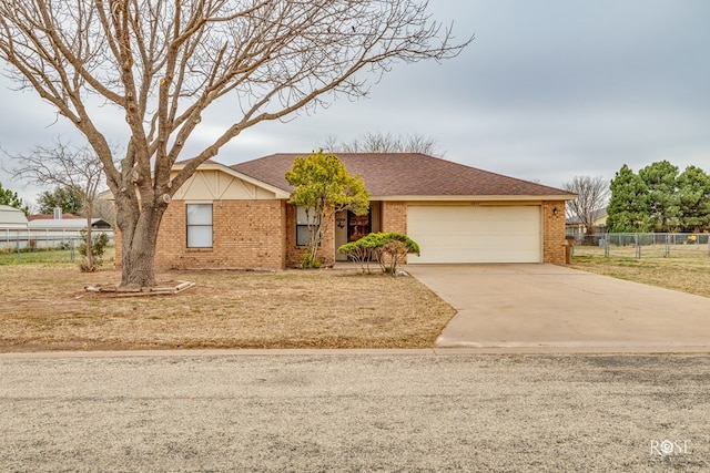 ranch-style house with brick siding, roof with shingles, concrete driveway, an attached garage, and fence