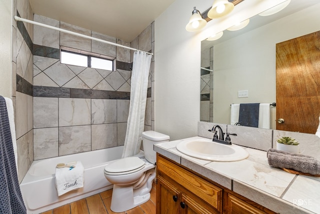 full bath featuring toilet, wood finished floors, shower / bath combination with curtain, and vanity