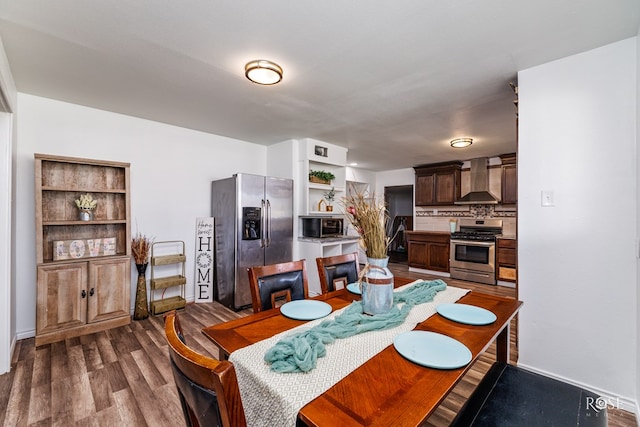 dining area featuring dark hardwood / wood-style flooring and built in features