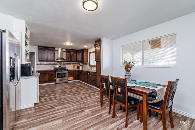 dining space featuring sink and light hardwood / wood-style floors