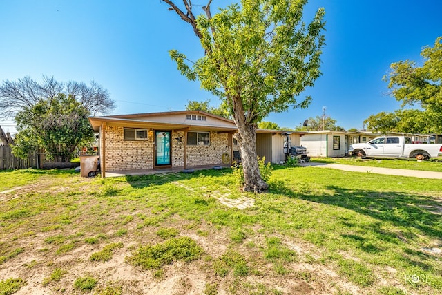 ranch-style house featuring a garage and a front lawn