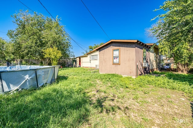 view of yard with a fenced in pool