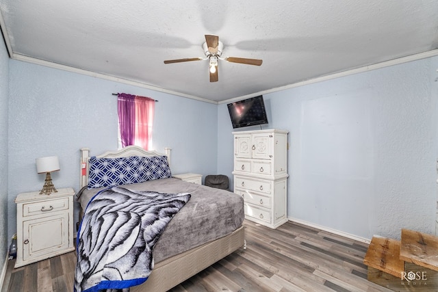 bedroom with crown molding, hardwood / wood-style floors, a textured ceiling, and ceiling fan