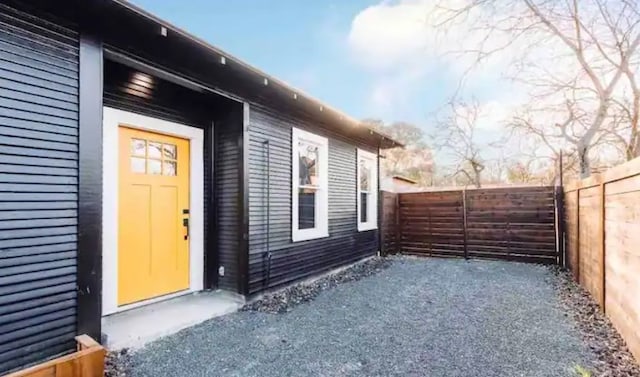 entrance to property featuring fence