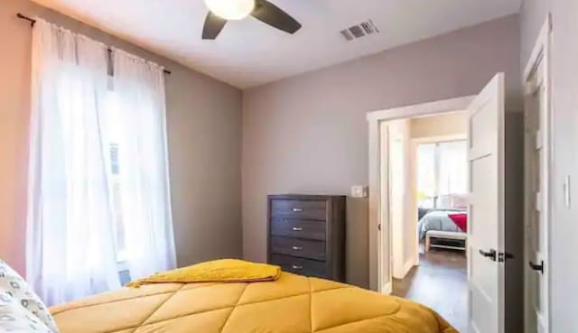 bedroom featuring visible vents and ceiling fan