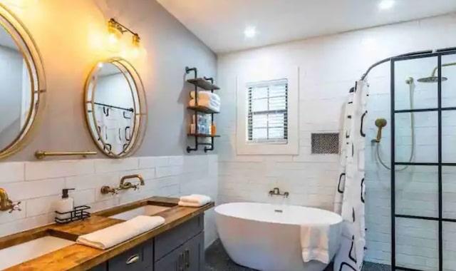 bathroom featuring a tile shower, a soaking tub, tile walls, and vanity