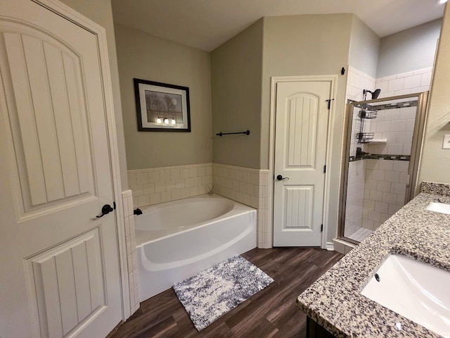1901 Chesney Ln, San Angelo, TX 76904 - bathroom with wood finished floors, a bath, a shower stall, and vanity