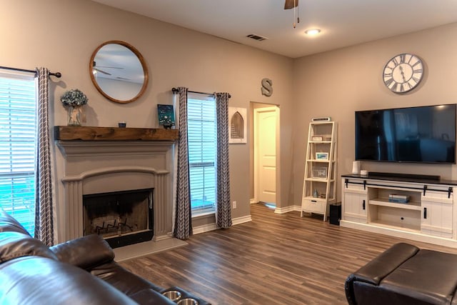1901 Chesney Ln, San Angelo, TX 76904 - living room featuring a ceiling fan, wood finished floors, baseboards, and a fireplace with raised hearth