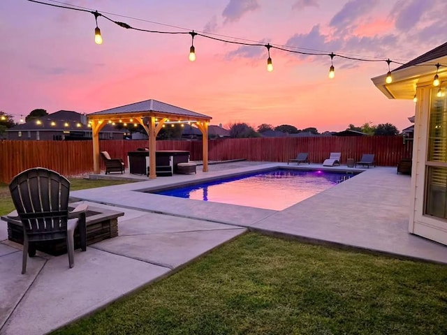 1901 Chesney Ln, San Angelo, TX 76904 - pool at dusk featuring a gazebo, a patio area, a hot tub, and an outdoor fire pit
