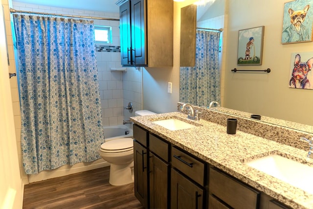 1901 Chesney Ln, San Angelo, TX 76904 - bathroom featuring toilet, double vanity, shower / bathtub combination with curtain, and wood finished floors