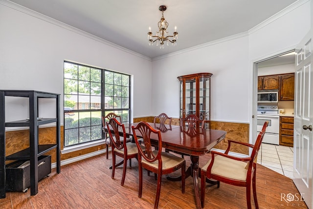 3405 Shadyhill Dr, San Angelo, TX 76904 - dining area featuring a chandelier, ornamental molding, and wainscoting