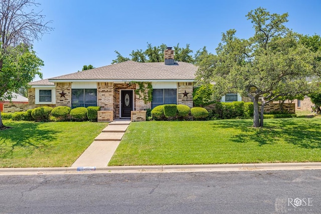 3405 Shadyhill Dr, San Angelo, TX 76904 - view of front facade featuring a front yard, a chimney, brick siding, and a shingled roof