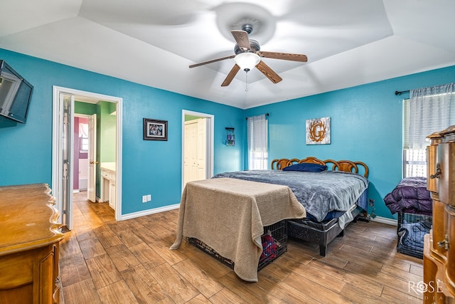 3405 Shadyhill Dr, San Angelo, TX 76904 - bedroom with wood finished floors, a tray ceiling, baseboards, and a ceiling fan
