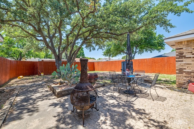 3405 Shadyhill Dr, San Angelo, TX 76904 - fenced backyard with a fire pit, a patio area, and outdoor dining space