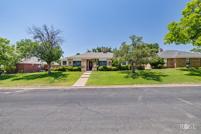 3405 Shadyhill Dr, San Angelo, TX 76904 - ranch-style house with a front lawn, a chimney, and brick siding