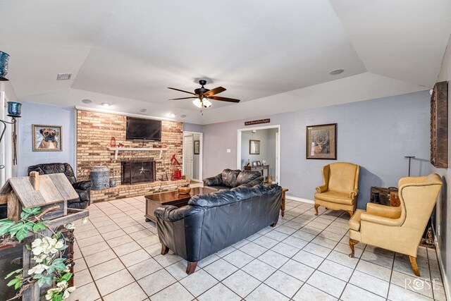 3405 Shadyhill Dr, San Angelo, TX 76904 - living room featuring light tile patterned flooring, a tray ceiling, a brick fireplace, a ceiling fan, and baseboards