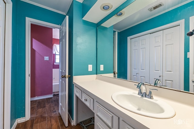 3405 Shadyhill Dr, San Angelo, TX 76904 - bathroom featuring crown molding, vanity, wood finished floors, and baseboards