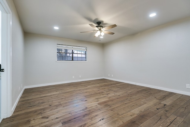 unfurnished room featuring ceiling fan and dark hardwood / wood-style flooring