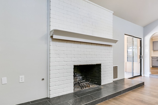 details with hardwood / wood-style flooring and a fireplace